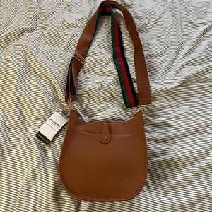 Brown Crossbody Saddle Bag with Green-Red Stripe Strap